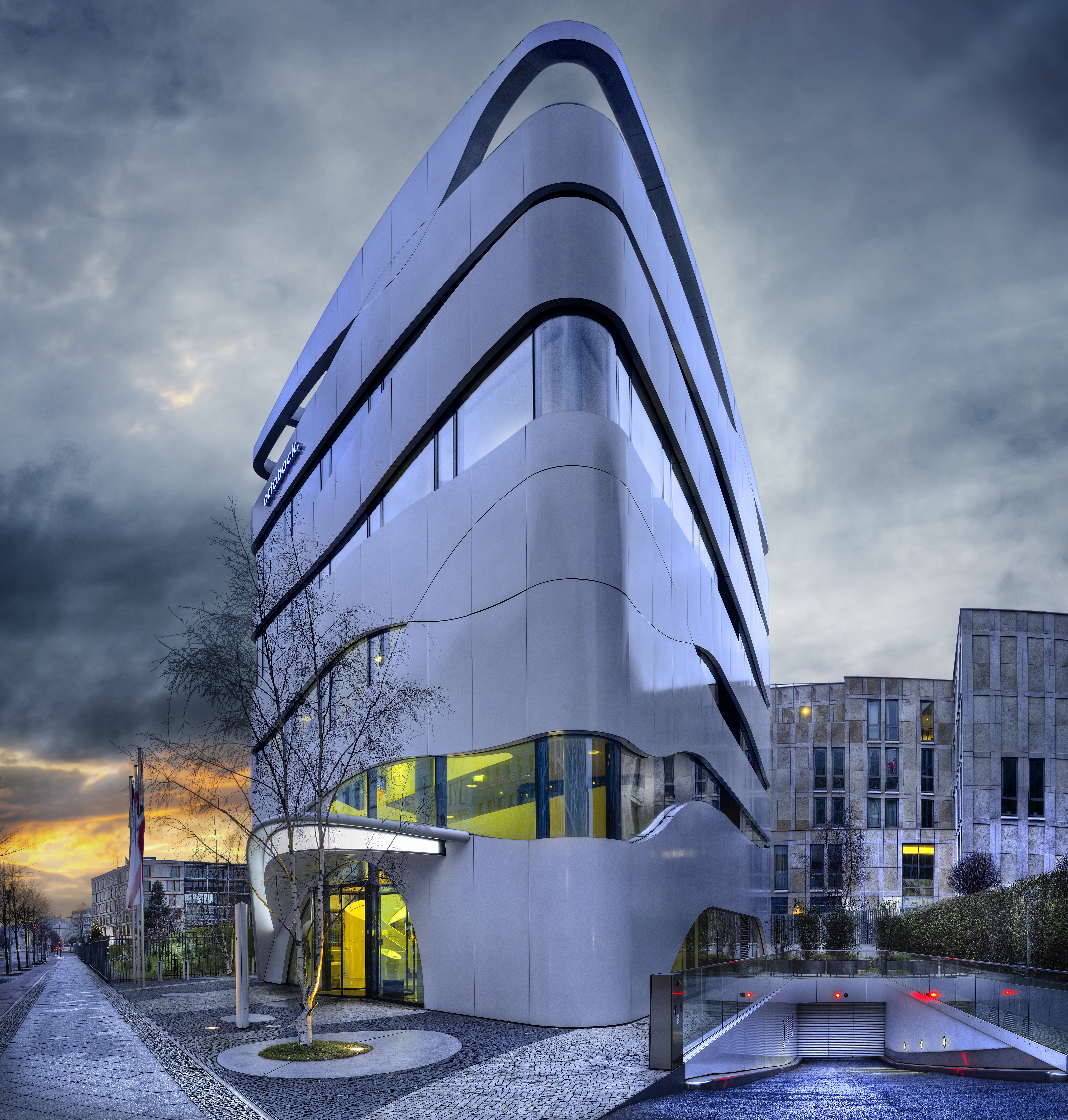 A facade of a modern building with geometric windows and curved walls